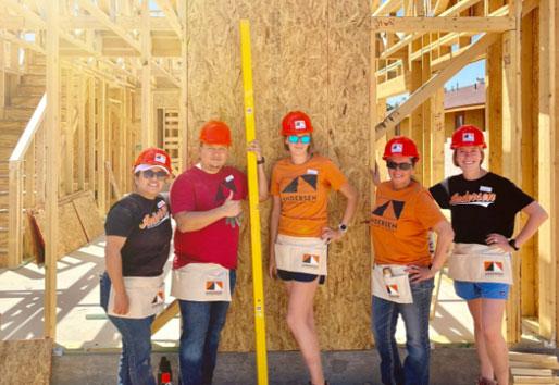 Andersen volunteers working on a house build