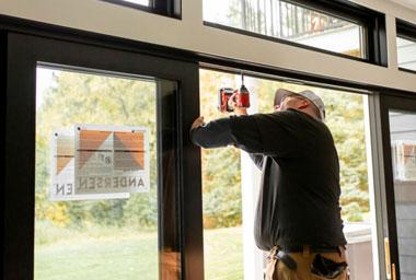 contractor replacing patio door with andersen contemporary patio door