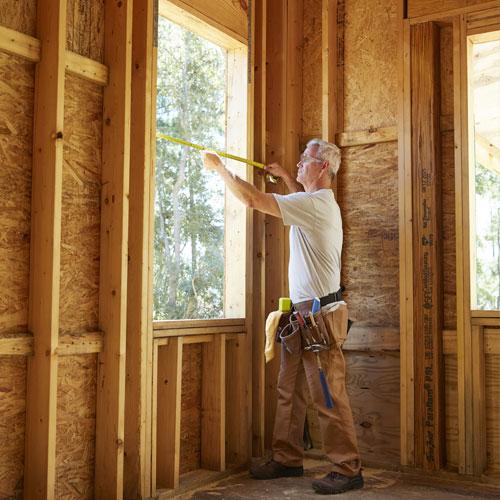 contractor working on installing andersen window