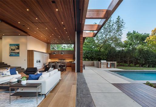 A Liftslide Door with a patented flush drainage track makes the wall between a living room and pool area completely disappear.