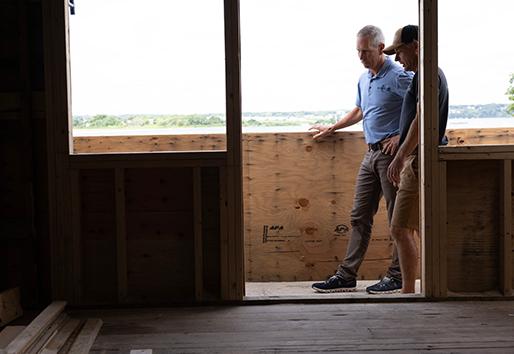 Andersen contractor walking inside house with customer