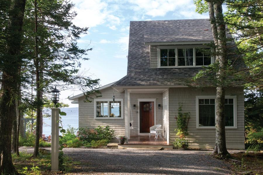 A shed dormer on a lake house features three Andersen windows