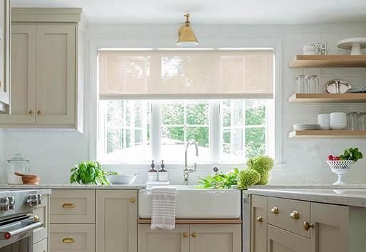 Kitchen with white garden window with grids and tan cupboards