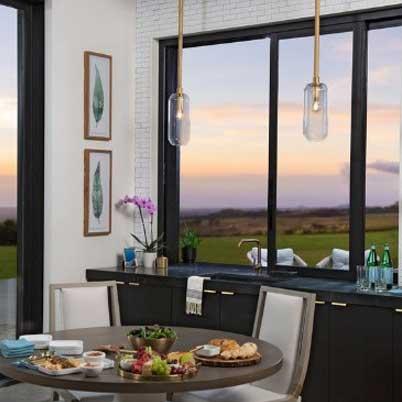 Modern kitchen with black windows and cupboards and white walls