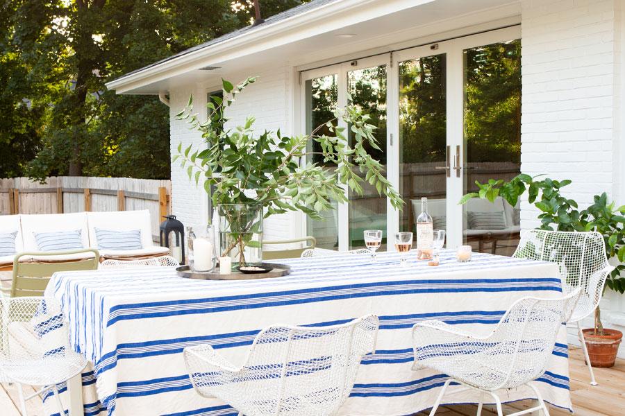 An outdoor meal on the sunny deck is made easy thanks to the folding outswing doors connecting to the kitchen inside