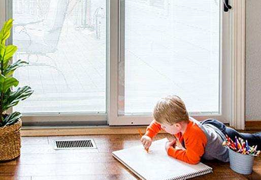 Kid in front of gliding patio door coloring, Inspiration for Moms Patio Door 200 Series Blinds in Glass