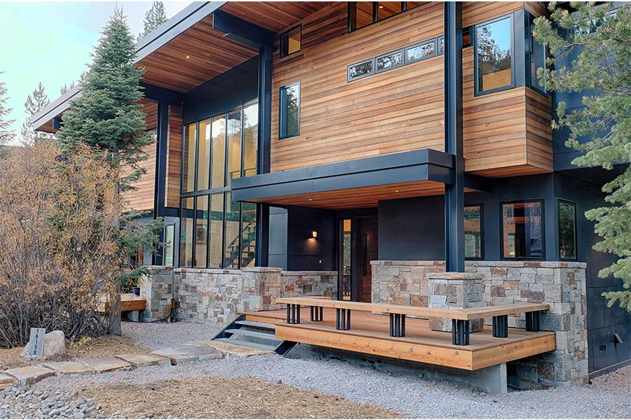 A home with black windows, iron ore exterior paint color, tricorn black trim and nearly brown accents.