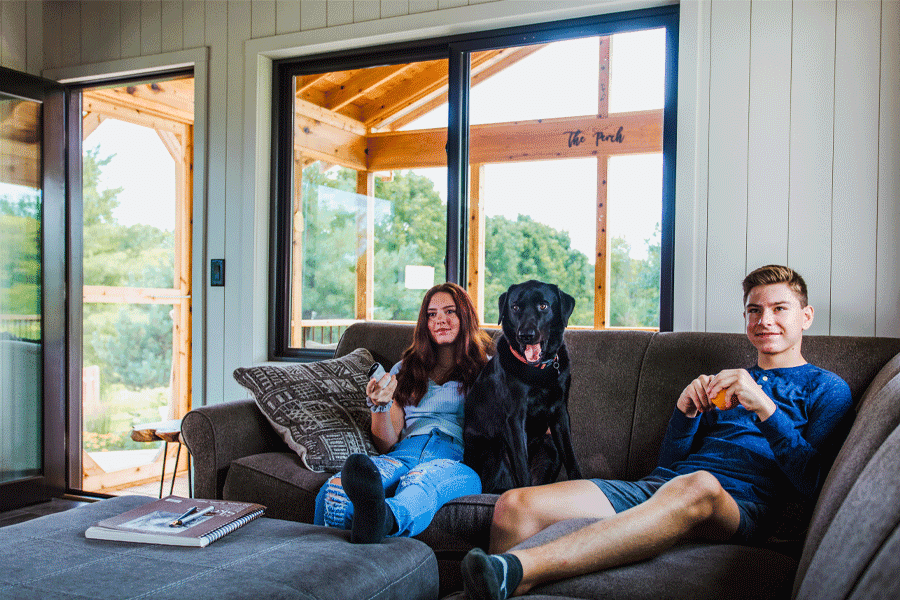 Kids and their dog relax on a couch.