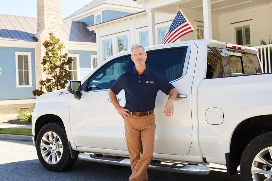 Andersen contractor standing in front of white truck