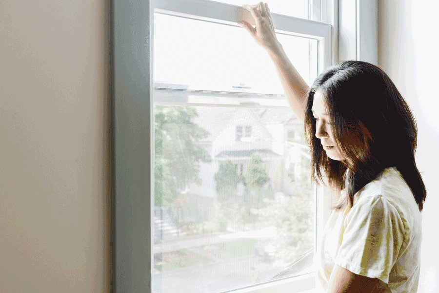 A woman opens her window.