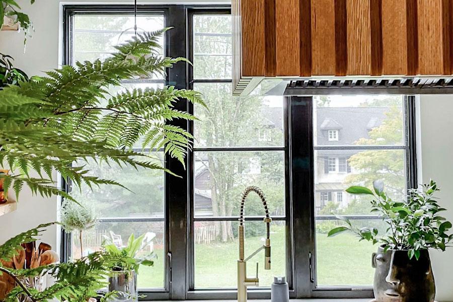 Black windows with a specified equal light grille pattern over the sink help create a modern look in this kitchen.