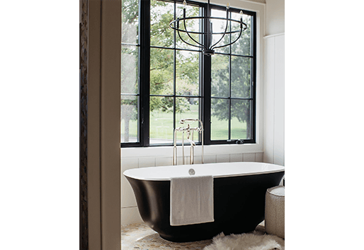 Freeman custom homes Large black windows with grilles over freestanding bathtub in bathroom