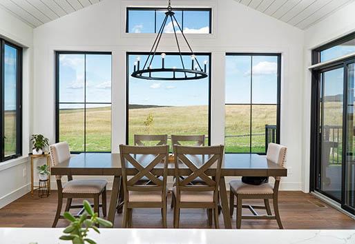 joe vetter construction dining room with oversized black windows