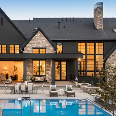 exterior of house with pool in front showing black andersen windows