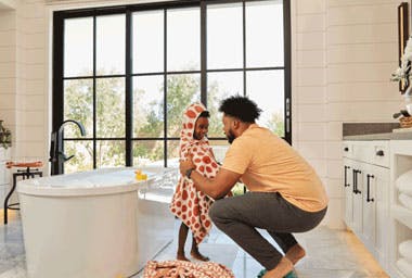 dad and son in bathroom drying off after bath