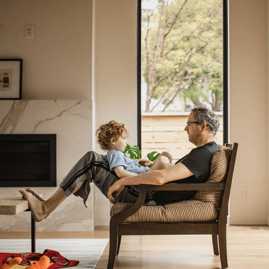 dad sitting in chair with son on his lap