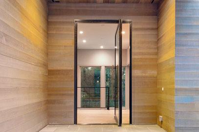 view of wooden exterior entryway with andersen pivot door