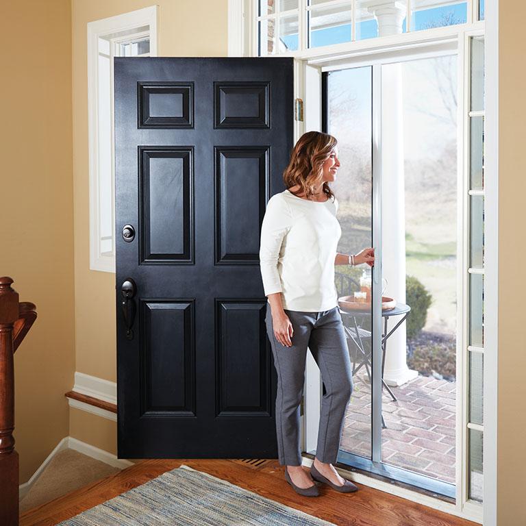 woman looking out front door