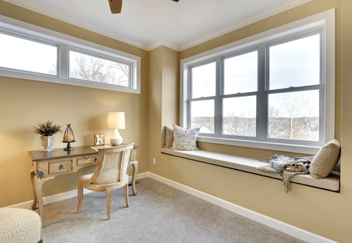 Interior of tan living space with white Andersen composite windows