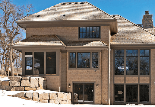 Exterior of brown house with Andersen vinyl windows and patio doors