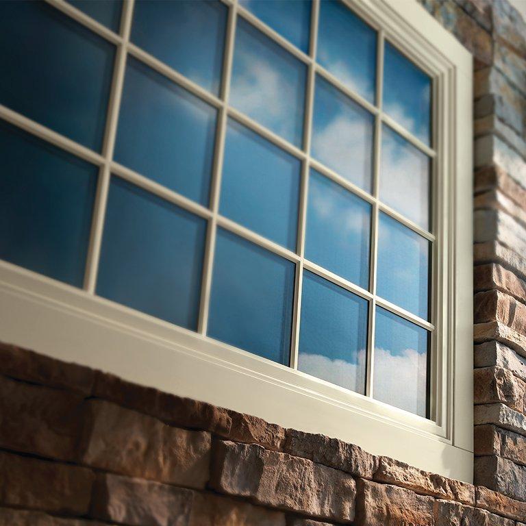 Tan Andersen vinyl window with colonial grilles