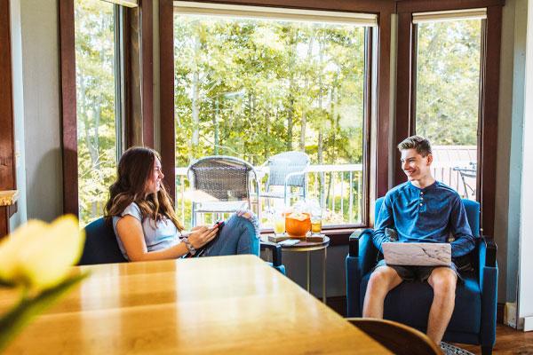 man and woman sitting in front of Andersen bay bow window